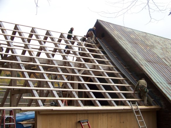 Working on roof of historic timber frame_green mountain timber frames_vermont