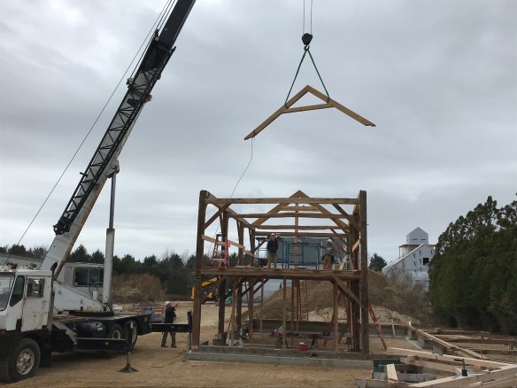 Rafter trusses are flown into place__Green Mountain Timber Frames